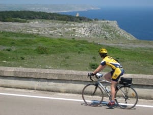 A cyclist passes through the Puglia landscape