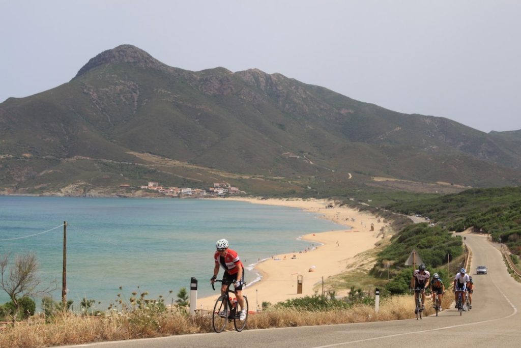 Cyclists biking along the Sardinian coast